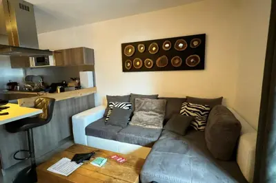 a living room with a couch and a table at In The City Center With A View Of Mont Blanc in Chamonix-Mont-Blanc