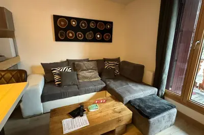 a living room with a couch and a coffee table at In The City Center With A View Of Mont Blanc in Chamonix-Mont-Blanc