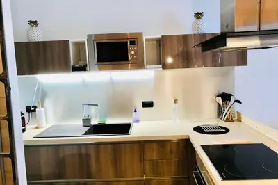 a kitchen with a sink and a microwave at In The City Center With A View Of Mont Blanc in Chamonix-Mont-Blanc