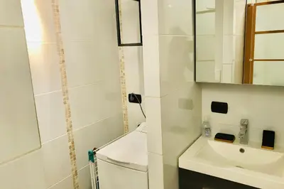 a white bathroom with a sink and a mirror at In The City Center With A View Of Mont Blanc in Chamonix-Mont-Blanc