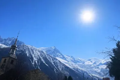 a hotel in the snow in front of a mountain at In The City Center With A View Of Mont Blanc in Chamonix-Mont-Blanc