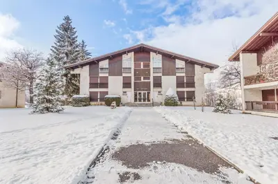 a large building with snow in front of it at Appartement Mazot - Welkeys in Megève