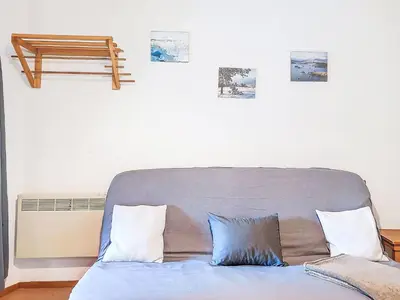 a couch in a room with pictures on the wall at Apartment Pierres Blanches F et H-10 by Interhome in Le Cugnon