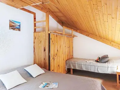 a bedroom with two beds and a wooden ceiling at Apartment Pierres Blanches F et H-10 by Interhome in Le Cugnon