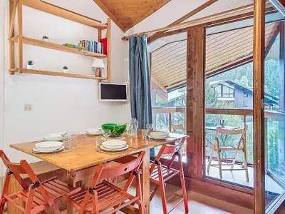 a dining room with a wooden table and chairs at Apartment Pierres Blanches F et H-10 by Interhome in Le Cugnon