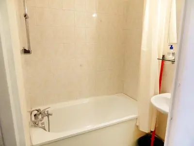 a bathroom with a bath tub and a sink at Studio L'Enclave I et J-28 by Interhome in Les Contamines-Montjoie