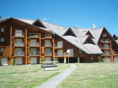 a large building with a bench in front of it at Studio L'Enclave I et J-28 by Interhome in Les Contamines-Montjoie