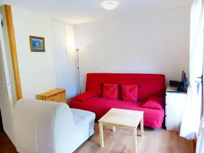 a dining room with a table and chairs and a tv at Studio L'Enclave I et J-28 by Interhome in Les Contamines-Montjoie