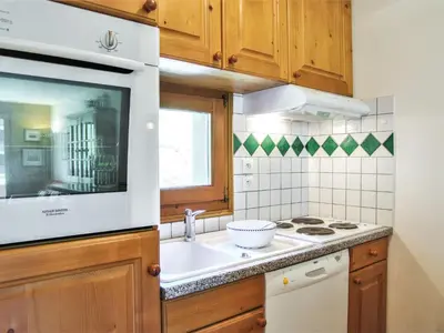 a kitchen with a sink and a microwave at Apartment Les Capucins by Interhome in Chamonix-Mont-Blanc