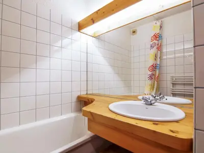 a bathroom with a sink and a bath tub at Studio Les Jardins du Mont-Blanc-4 by Interhome in Chamonix-Mont-Blanc