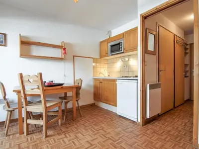 a small kitchen with a table and a dining room at Studio Les Jardins du Mont-Blanc-4 by Interhome in Chamonix-Mont-Blanc