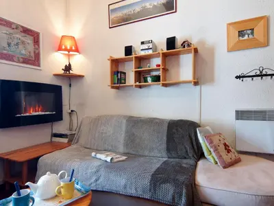 a living room with a couch and a tv at Apartment Le Chailloud-2 by Interhome in Chamonix-Mont-Blanc