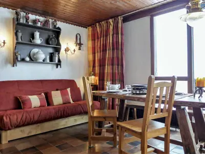 a living room with a red couch and a table at Studio Lognan-1 by Interhome in Chamonix-Mont-Blanc