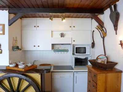 a kitchen with white cabinets and a counter top at Studio Lognan-1 by Interhome in Chamonix-Mont-Blanc