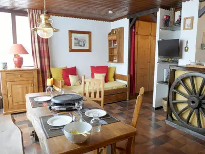 a kitchen and living room with a wooden table at Studio Lognan-1 by Interhome in Chamonix-Mont-Blanc