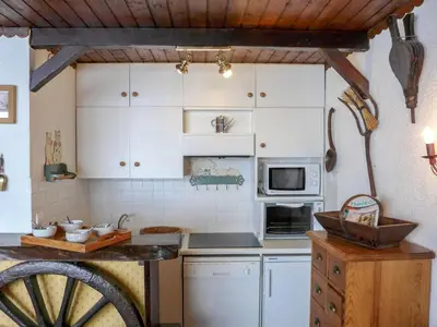 a kitchen with white cabinets and a counter top at Studio Lognan-1 by Interhome in Chamonix-Mont-Blanc