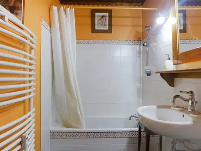 a bathroom with a tub and a sink and a shower at Studio Lognan-1 by Interhome in Chamonix-Mont-Blanc