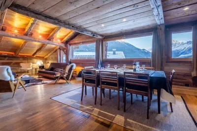 a dining room with a table and chairs and mountains at Authenthic Chalet Ski on Les Houches Chamonix in Les Houches