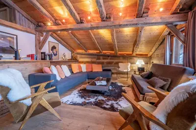 a living room with a blue couch and chairs at Authenthic Chalet Ski on Les Houches Chamonix in Les Houches