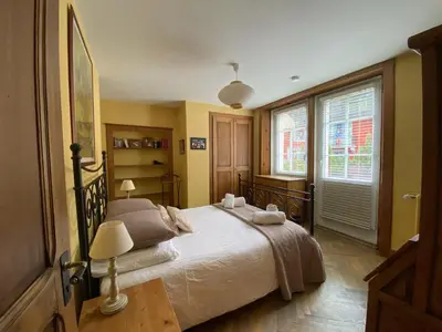a bedroom with a large bed and a window at Villa Léon in Chamonix-Mont-Blanc