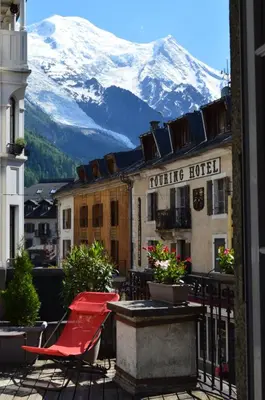 a view from a balcony of a hotel with a snow covered mountain at Villa Léon in Chamonix-Mont-Blanc