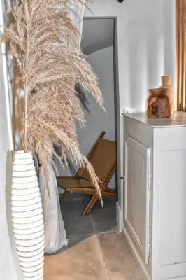 a vase with a palm plant in a room at Apartment WABI-SABI by JAPANDI home in Megève