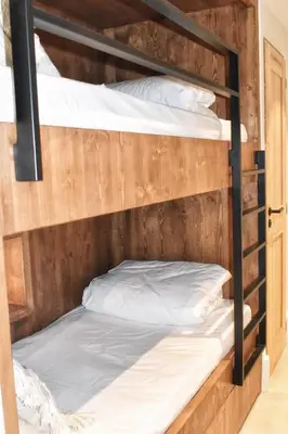 two bunk beds with white pillows on them at Apartment WABI-SABI by JAPANDI home in Megève