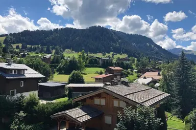 a village in a valley with mountains in the background at Apartment WABI-SABI by JAPANDI home in Megève