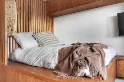 a bedroom with a bed with a blanket on it at Apartment WABI-SABI by JAPANDI home in Megève