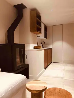 a living room with a couch and a kitchen at Apartment WABI-SABI by JAPANDI home in Megève