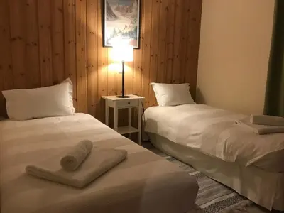 two beds sitting next to each other in a room at Chalet du grand cerf in Servoz