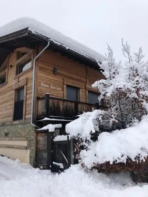 a log cabin in the snow in front at Chalet Plan Glacier in Chamonix-Mont-Blanc