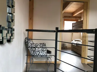 a room with a bunk bed and a chair at Chalet Plan Glacier in Chamonix-Mont-Blanc