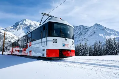 a train is on the tracks in the snow at Elegant historic apartment Le Mont Joly - 3 bed 2bath view 80m2 in Saint-Gervais-les-Bains