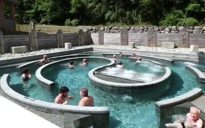 a group of people in a swimming pool at Elegant historic apartment Le Mont Joly - 3 bed 2bath view 80m2 in Saint-Gervais-les-Bains