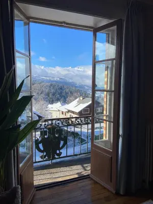 an open door to a balcony with a view at Elegant historic apartment Le Mont Joly - 3 bed 2bath view 80m2 in Saint-Gervais-les-Bains