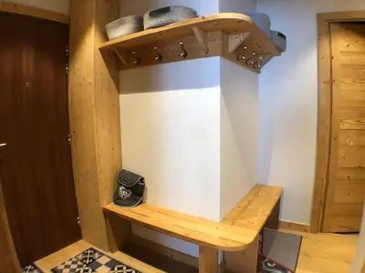 a room with a wooden shelf on the wall at Snow Rabbit Lodge in Chamonix-Mont-Blanc