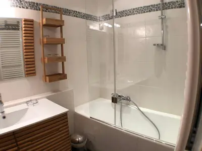 a bathroom with a shower and a tub and a sink at Snow Rabbit Lodge in Chamonix-Mont-Blanc