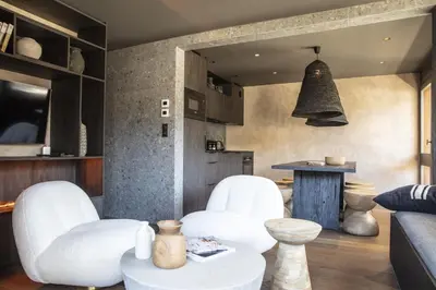 a living room with white chairs and a table at Apartment FERRONNE by JAPANDI home in Megève