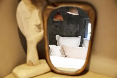 a mirror reflection of a bed in a bedroom at Apartment FERRONNE by JAPANDI home in Megève
