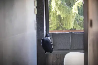 a couch sitting next to a window on a train at Apartment FERRONNE by JAPANDI home in Megève