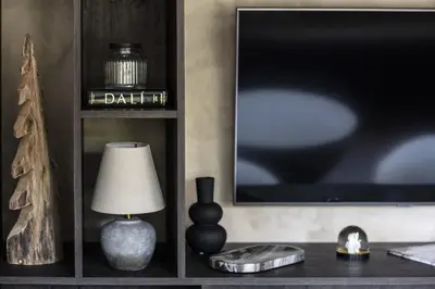 a living room with a tv and a table with a lamp at Apartment FERRONNE by JAPANDI home in Megève