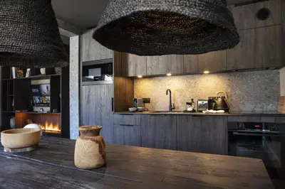 a kitchen with a wooden table with a vase on it at Apartment FERRONNE by JAPANDI home in Megève