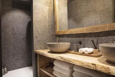 a bathroom with two sinks on a counter with towels at Apartment FERRONNE by JAPANDI home in Megève