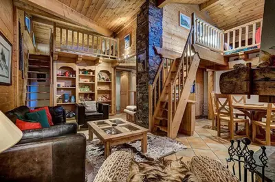 a living room with a couch and a table at MGM Parc Couttet in Chamonix-Mont-Blanc