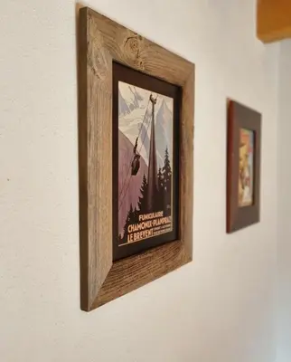 a picture on a wall with two pictures on it at MGM Parc Couttet in Chamonix-Mont-Blanc