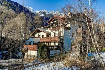 a large house in the middle of a mountain at MGM Parc Couttet in Chamonix-Mont-Blanc