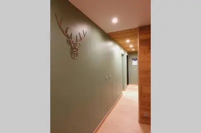a hallway with a wall with a deer head on it at *** Le Refuge *** Logement standing Megève in Demi-Quartier