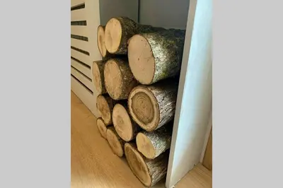 a pile of logs sitting next to a wall at *** Le Refuge *** Logement standing Megève in Demi-Quartier