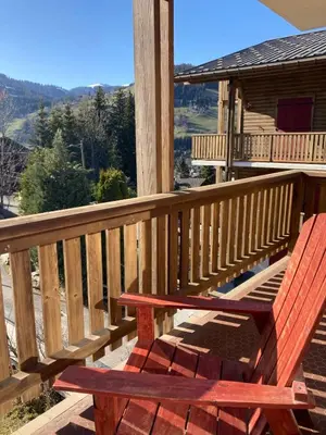 a wooden deck with a bench on a cabin at Apartment NAVAJO by JAPANDI home in Megève